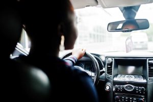 struggling with clutch control, woman driving