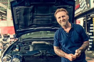 how to extend the life of your car, mechanic in front of car