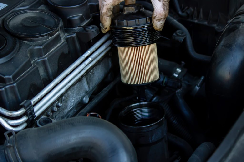 A mechanic removing a filter as part of DPF cleaning for cars
