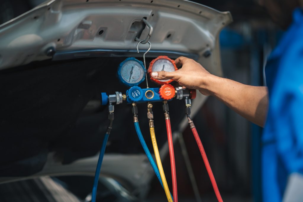 Mechanic showing car air conditioning maintenance tips for 2025