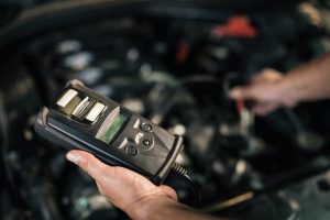 What is a diagnostic check on a car, car mechanic using a diagnostic tool on a vehicle.