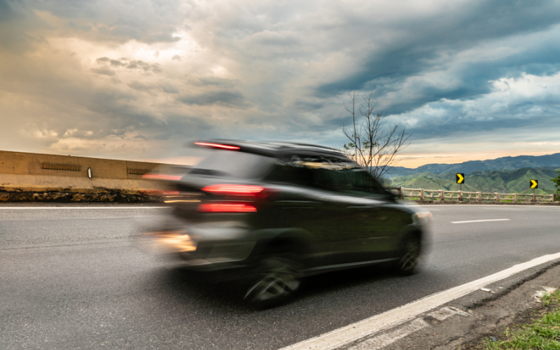 Car driving at high speed with motion blur representing vibration issues