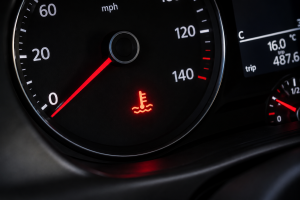 Engine temperature warning light illuminated on a vehicle instrument cluster