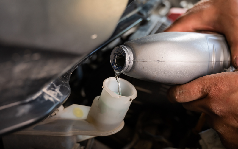 Brake fluid being topped up in a vehicle reservoir