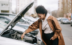 Driver checking the engine bay as part of routine car maintenance