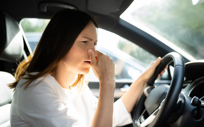Driver noticing a strong petrol smell inside their car while driving.
