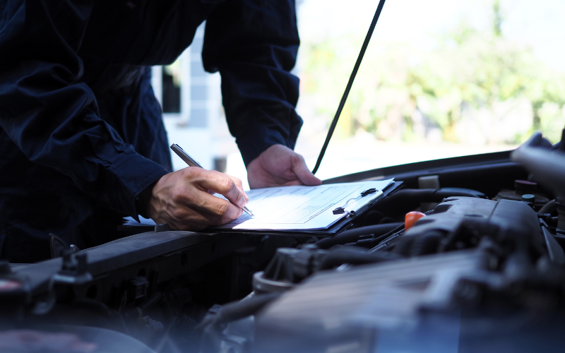 Mechanic inspecting a car during an MOT test