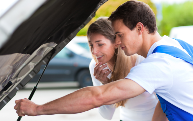 Mechanic checking under the bonnet of a car for a possible engine problem