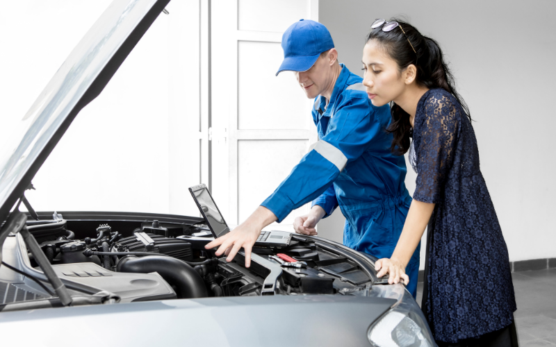 Mechanic inspecting a car after the driver noticed a burning smell