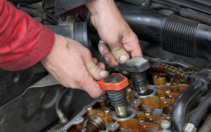 Mechanic inspecting ignition coils in a car engine